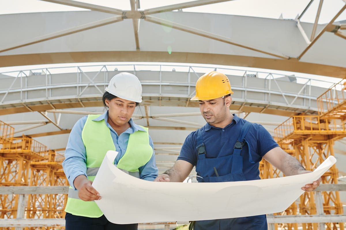 Professional team reviewing roofing project plans on site